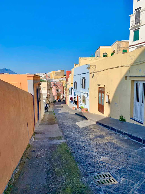 San Rocco street in Procida island a narrow alley crosses colored houses